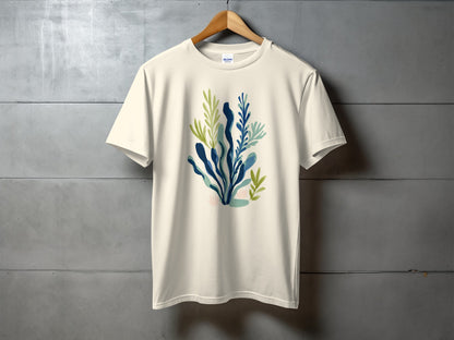 Cream t-shirt with watercolor abstract blue and green botanical illustration.