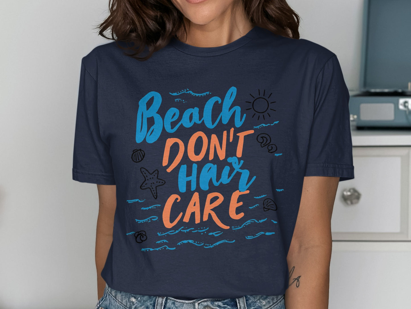 Dark blue t-shirt with "Beach Don't Hair Care" text and sun graphic.