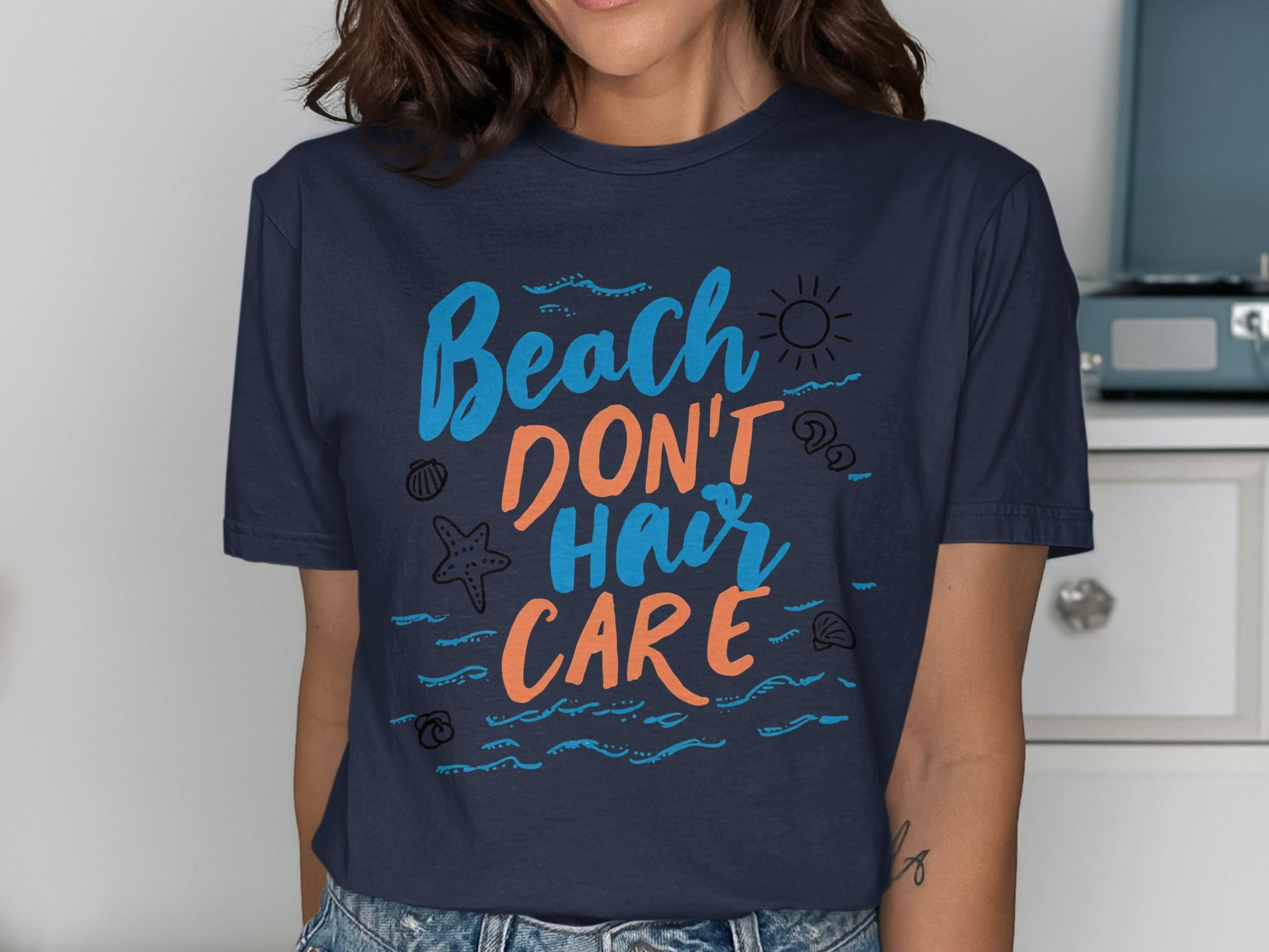 Dark blue t-shirt with "Beach Don't Hair Care" text and sun graphic.