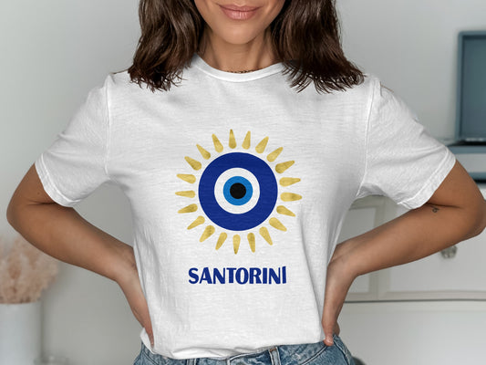 White t-shirt with blue and gold sun design and "SANTORINI" text.