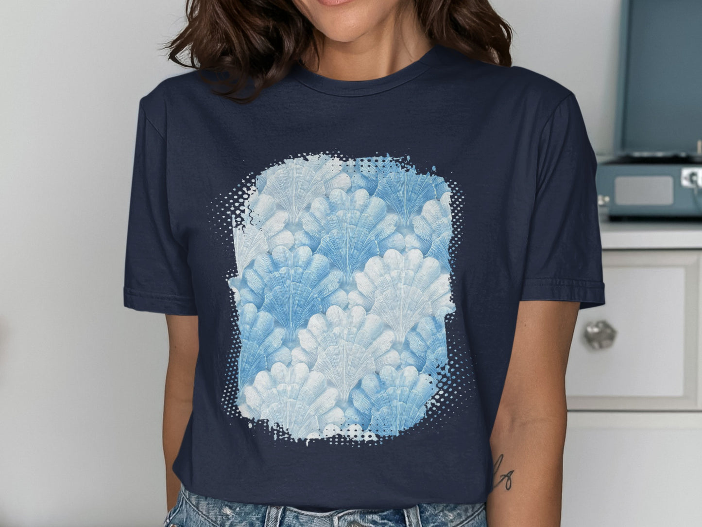 Navy t-shirt with a pale blue and white seashell pattern design.