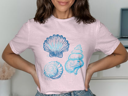 Light pink t-shirt with blue seashell graphics.