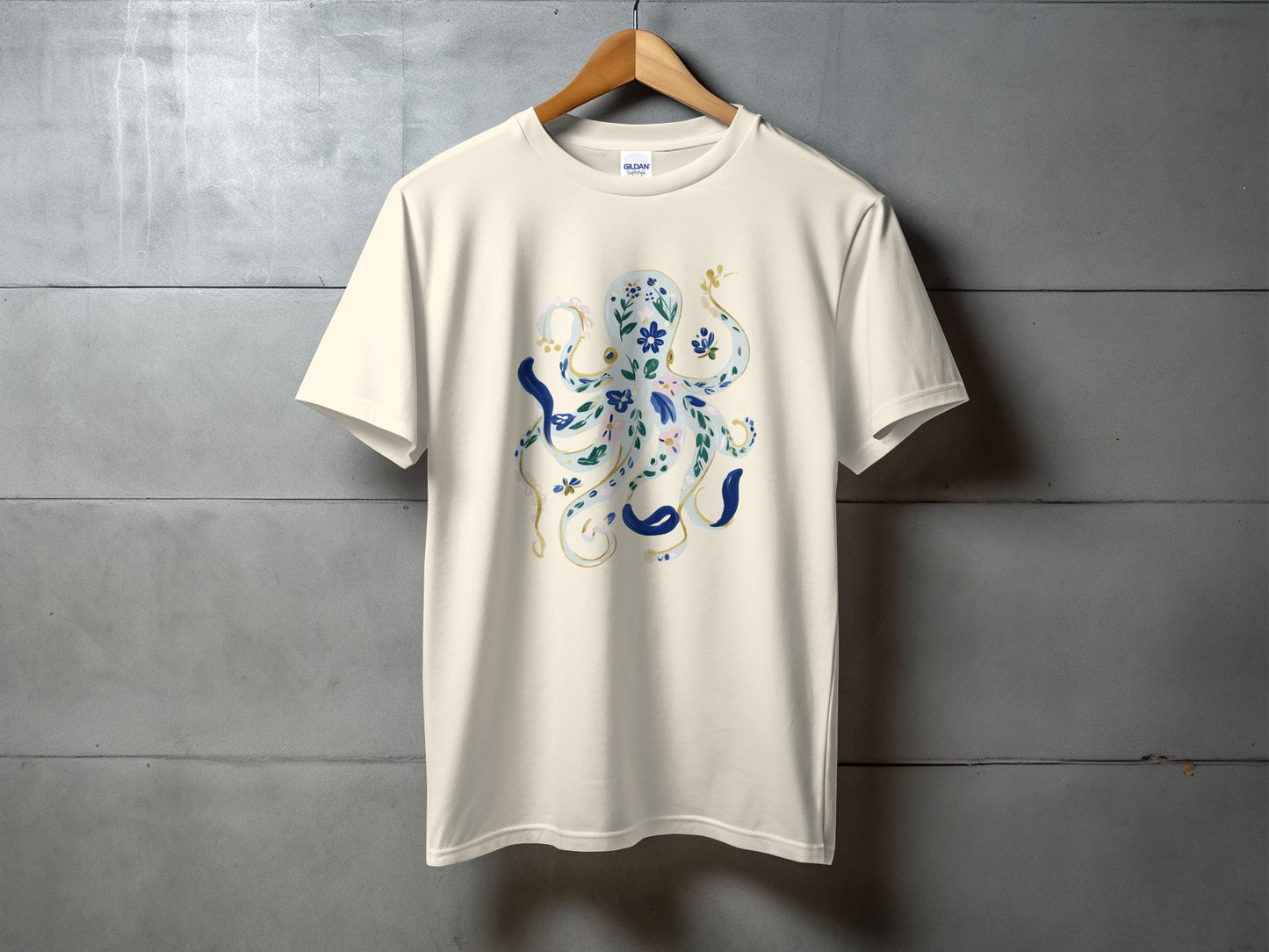 Cream t-shirt with a blue and gold floral octopus design.