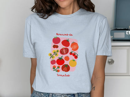 Light blue t-shirt with graphic of various tomatoes and text "Avances de Tomates".