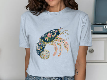 Light blue t-shirt featuring a hermit crab design with floral accents.