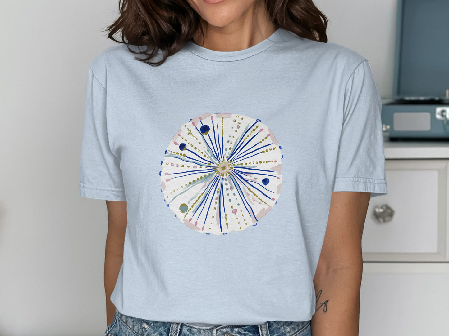 Light blue t-shirt with a watercolor sea urchin design.