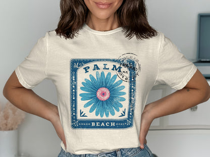 Cream t-shirt with "PALM BEACH" and blue flower graphic.