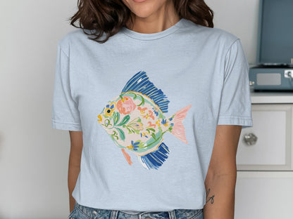 Light blue t-shirt with a colorful floral fish graphic.