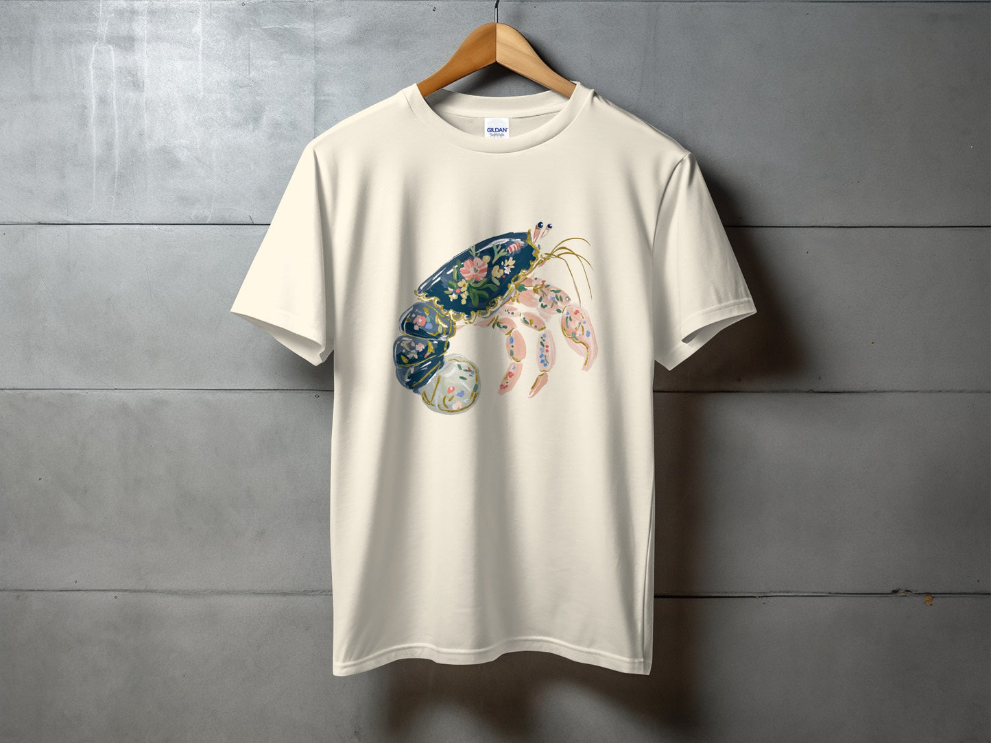 Cream t-shirt with a stylized floral crab graphic on the front.