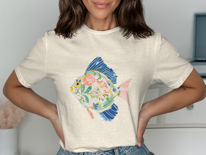 Cream t-shirt with colorful painted fish design.