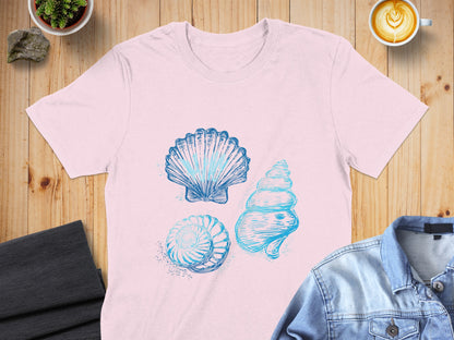 Light pink t-shirt with three blue sketched seashells.