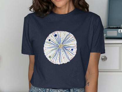 Dark navy t-shirt with a watercolor sea urchin design featuring pink and gold accents.