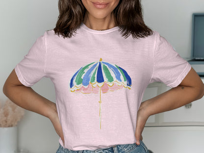 Pink t-shirt with a colorful striped umbrella graphic.