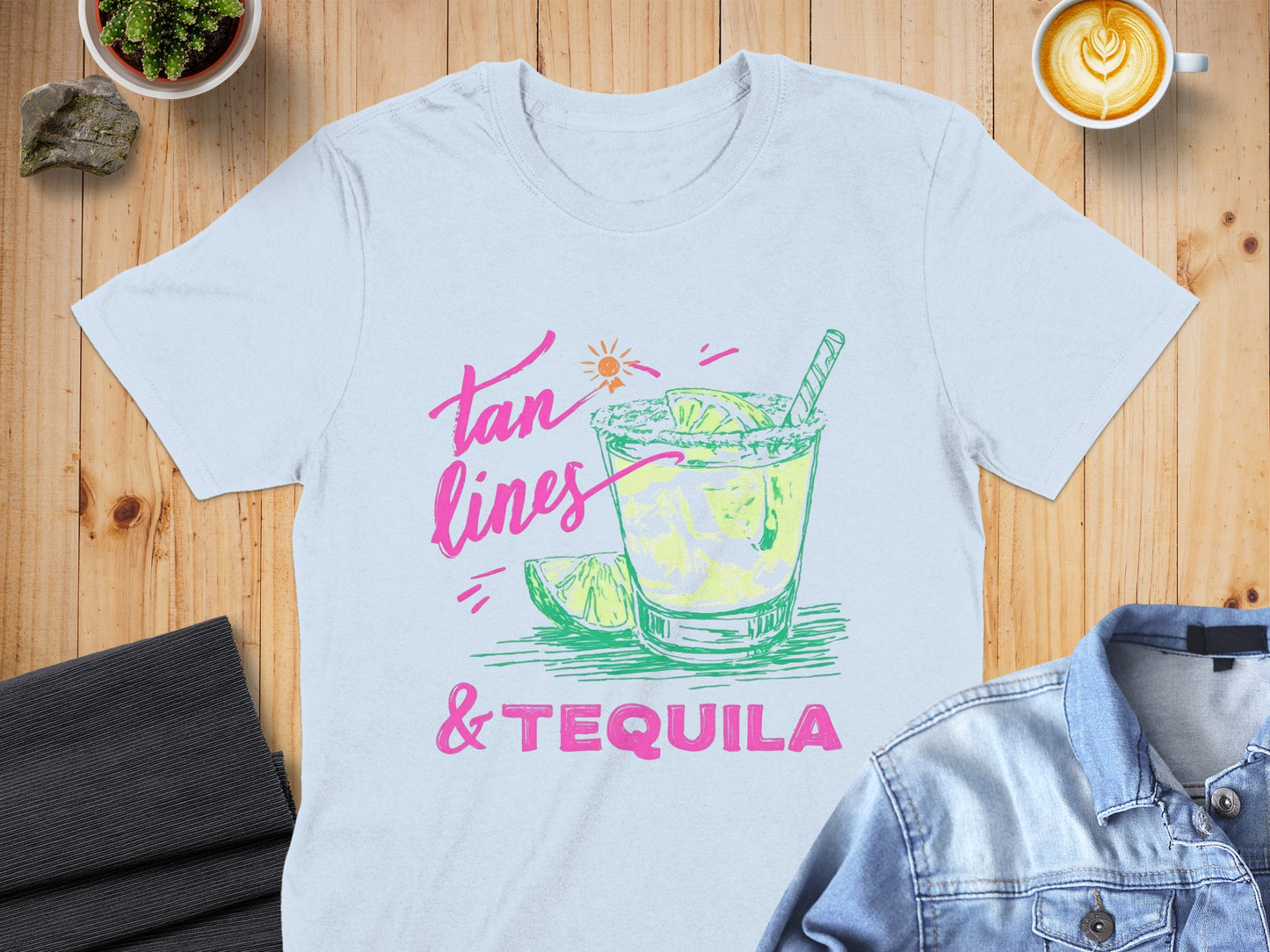 Light blue t-shirt with "tan lines & tequila" graphic of a margarita.