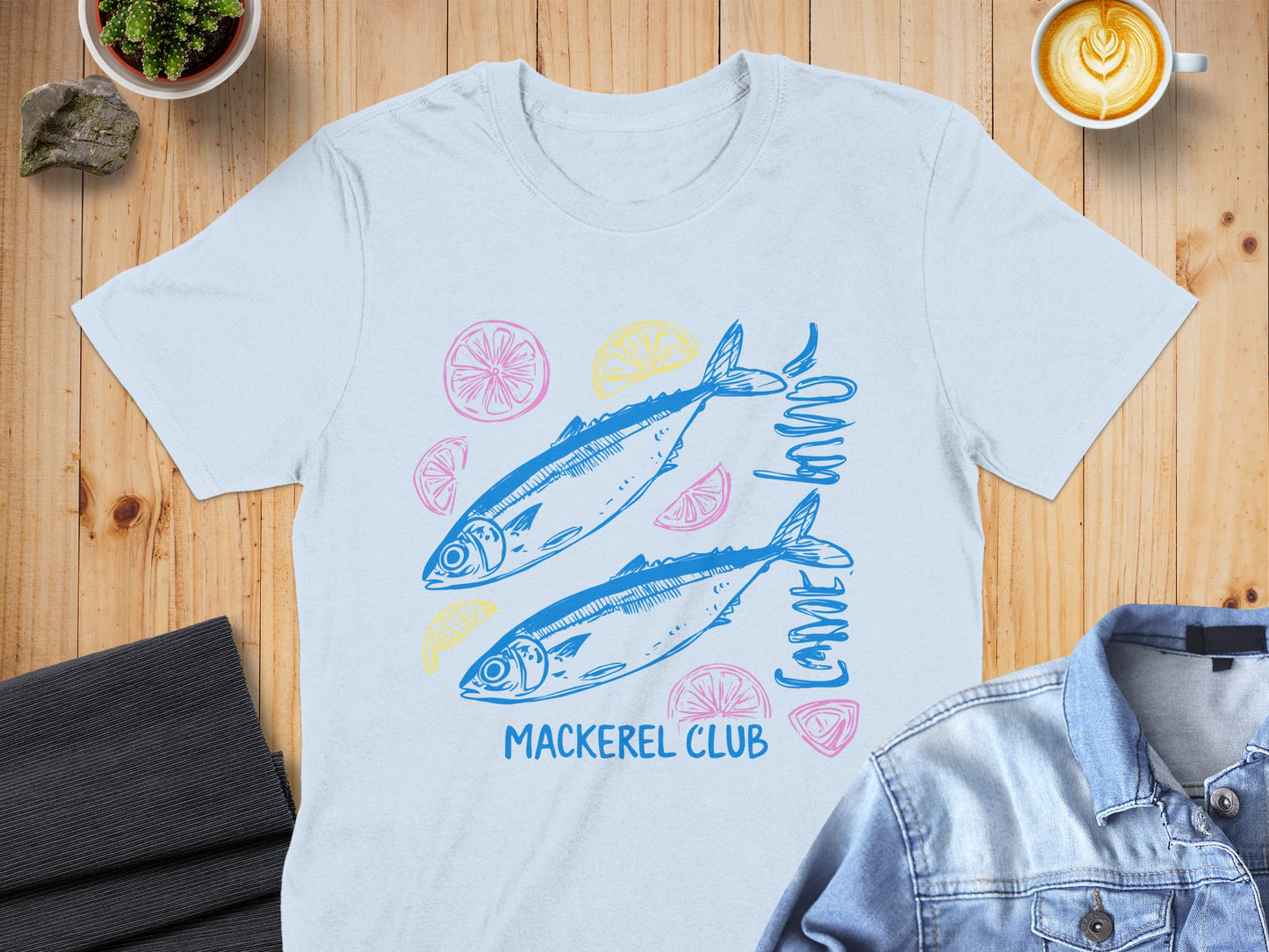 Blue t-shirt with two mackerel, lemons, and limes, and "Mackerel Club" text.
