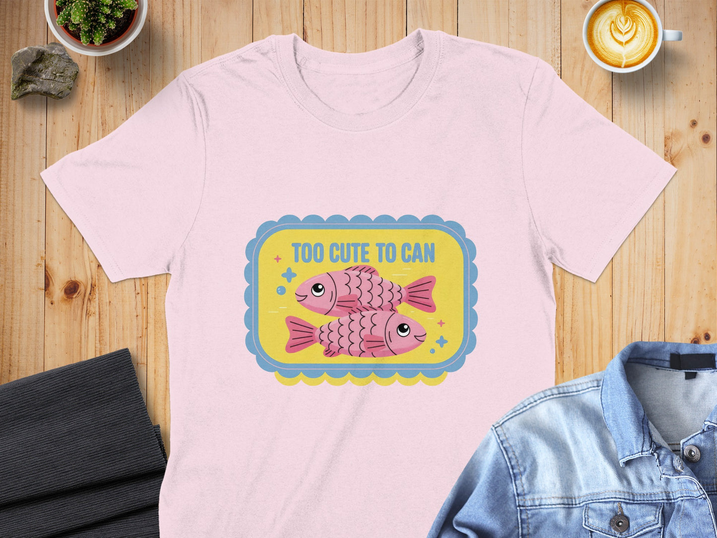 Pink t-shirt with two cartoon fish and "Too Cute to Can" text.