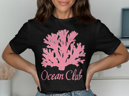 Black t-shirt with a pink coral design and "Ocean Club" text.
