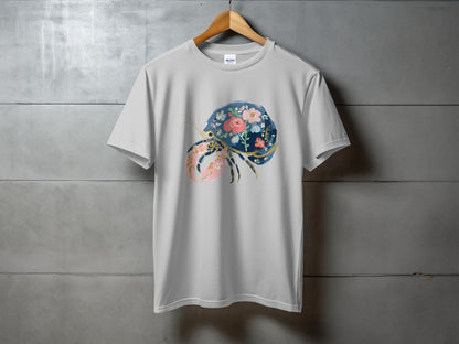 White t-shirt with a floral crab graphic on concrete background.