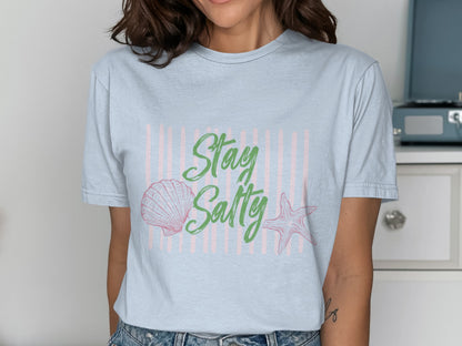 Light blue t-shirt with "Stay Salty" text, seashell, and starfish graphic.