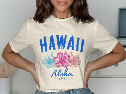 Cream t-shirt with "HAWAII Aloha 1997" and hibiscus flowers.