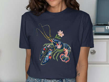 Navy t-shirt with a floral lobster graphic and pink flower accent.
