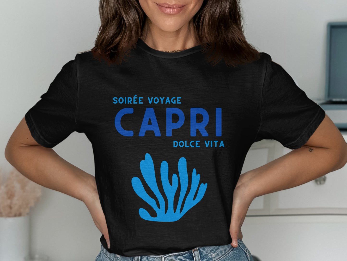 Black t-shirt with blue "Soirée Voyage Capri Dolce Vita" text and coral graphic.