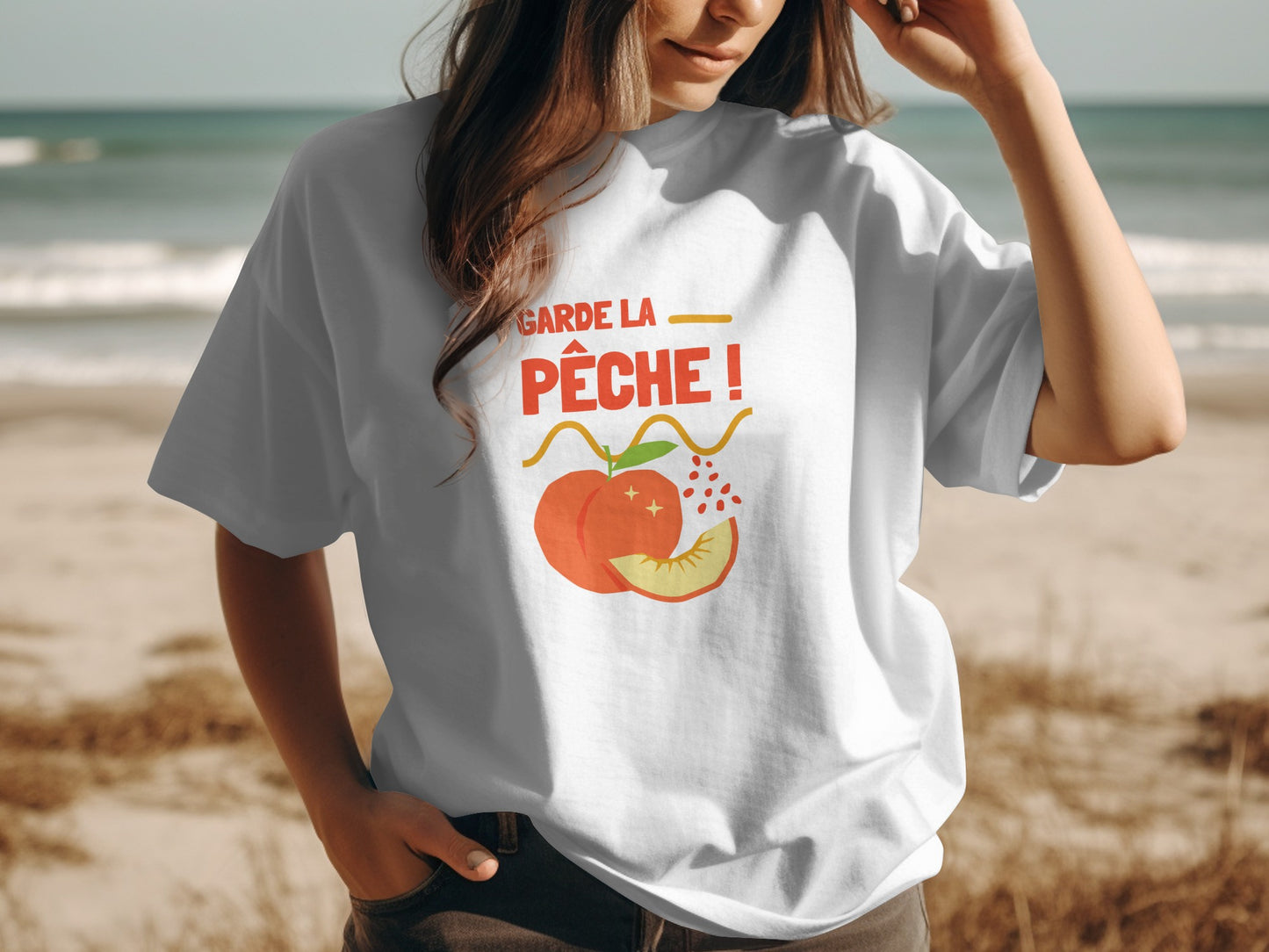 White t-shirt with "Garde la pêche!" text and peach graphic.