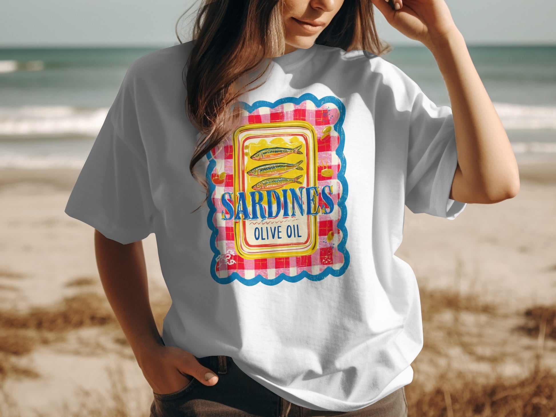 White t-shirt featuring a colorful graphic of a sardine can label.