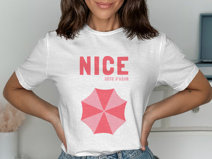 White t-shirt with "NICE CÔTE D'AZUR" and a pink umbrella graphic.