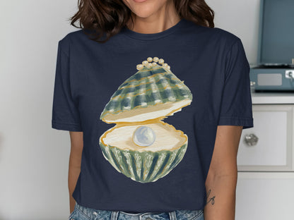 Navy t-shirt with watercolor painting of an open clam holding a pearl.