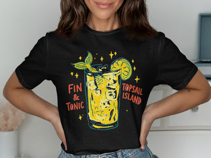 Black t-shirt with a graphic of a cocktail with a mermaid tail and lemon slice.