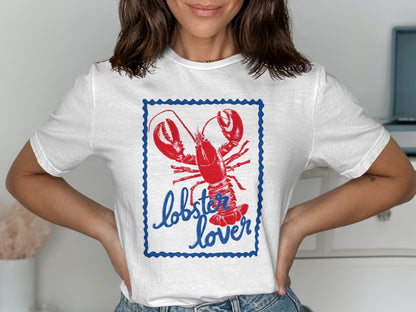 White t-shirt with a red lobster and "lobster lover" text in a blue frame.