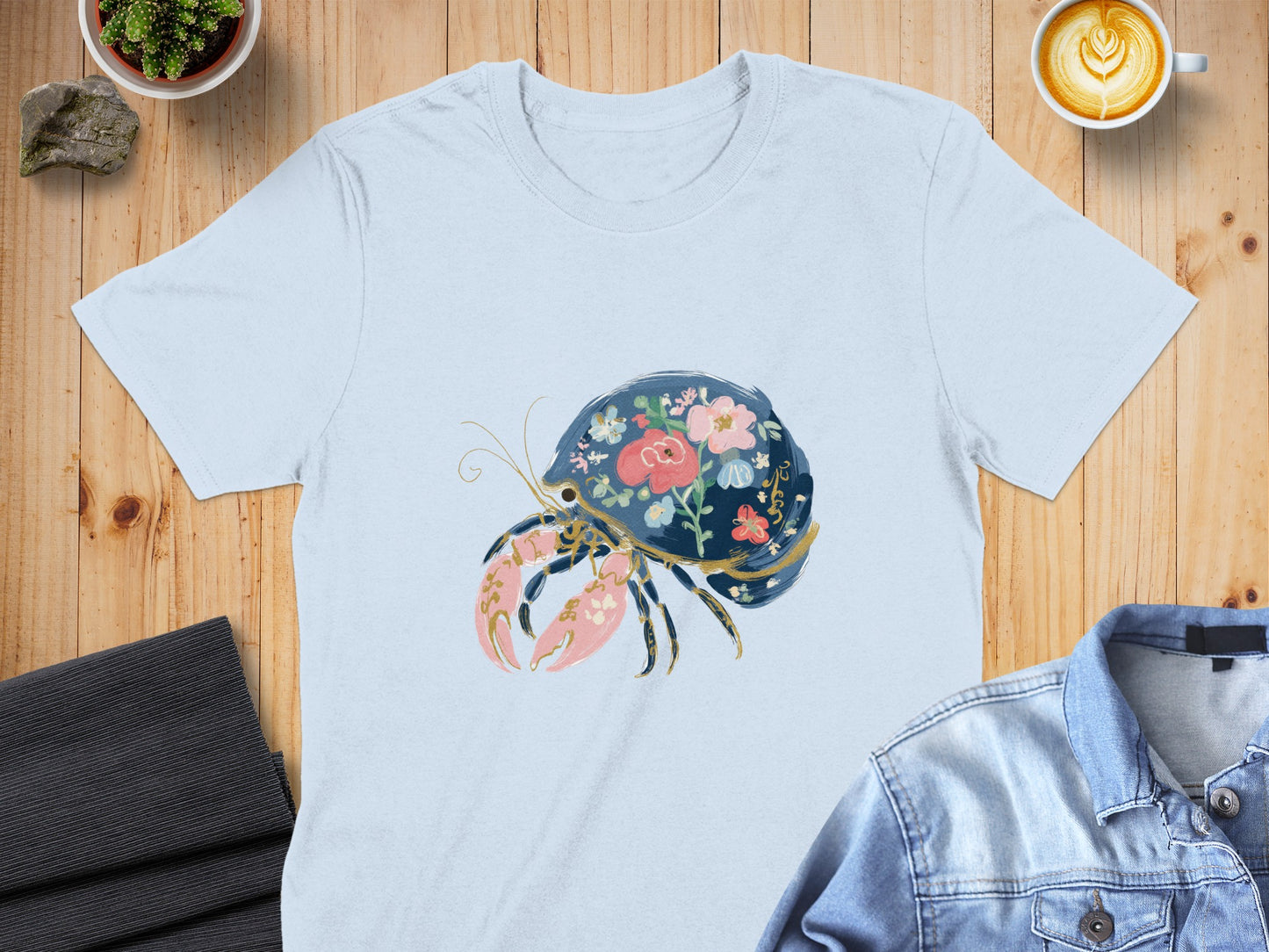 Light blue t-shirt with a floral hermit crab graphic.