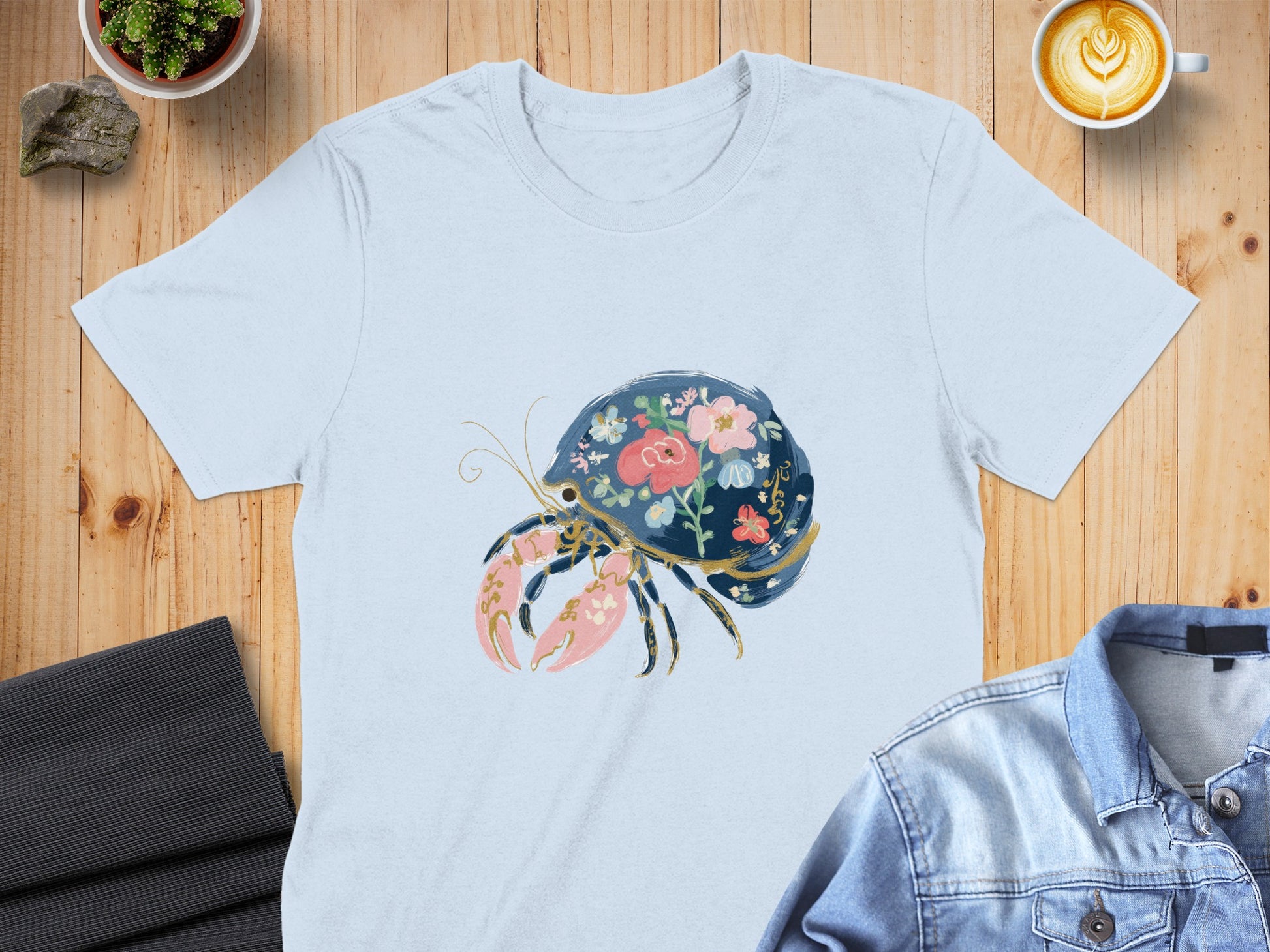 Light blue t-shirt with a floral hermit crab graphic.
