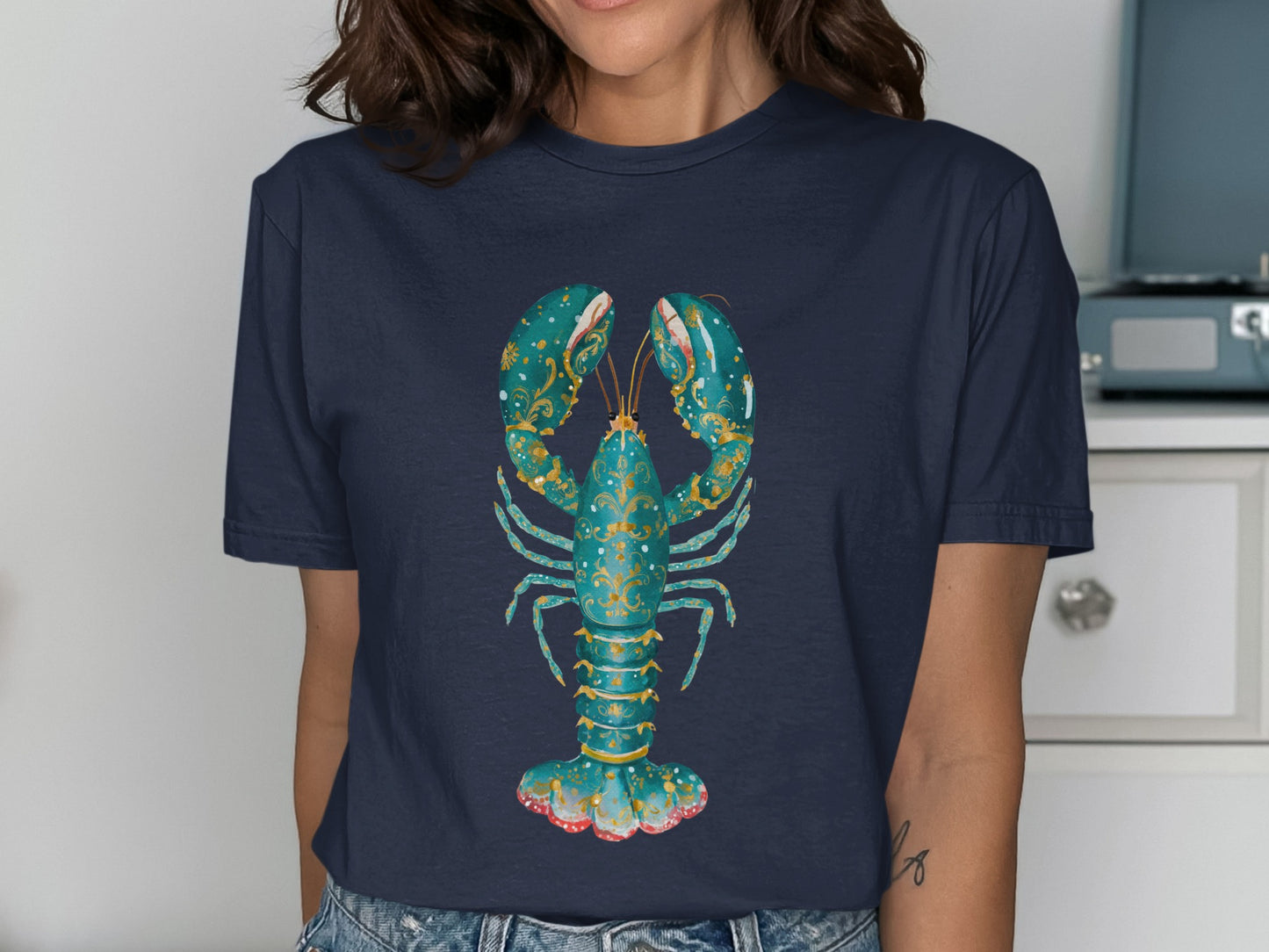 Dark blue t-shirt featuring a stylized teal lobster with gold ornate details.