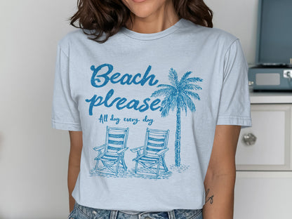 Light blue t-shirt with "Beach please" and palm tree, two beach chairs.