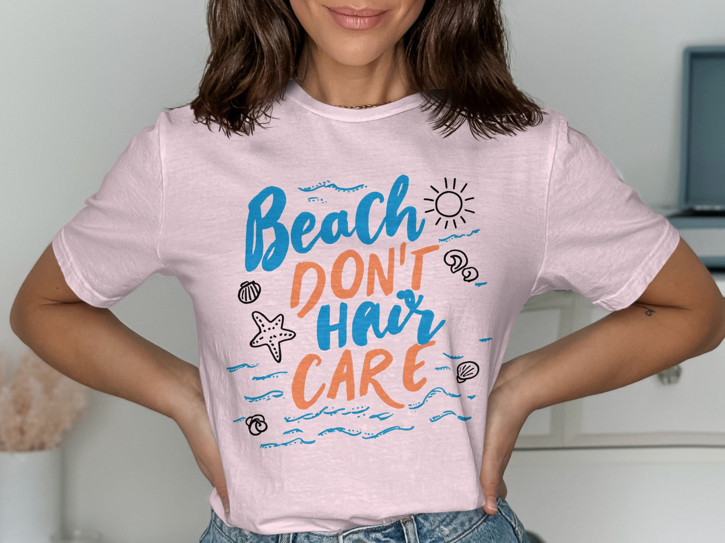 Pink t-shirt with "Beach Don't Hair Care" text and beach icons.