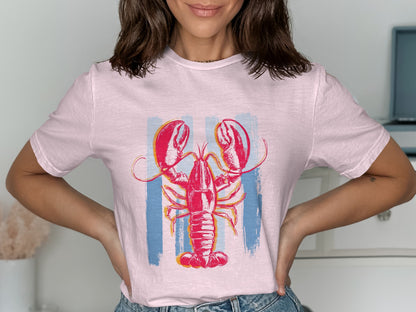 Pink t-shirt with a red lobster illustration over vertical blue stripes.