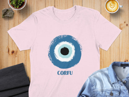 Pink t-shirt with a blue and white evil eye design and "CORFU" text.
