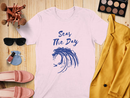 Pink t-shirt with "Seas The Day" and a blue wave graphic.