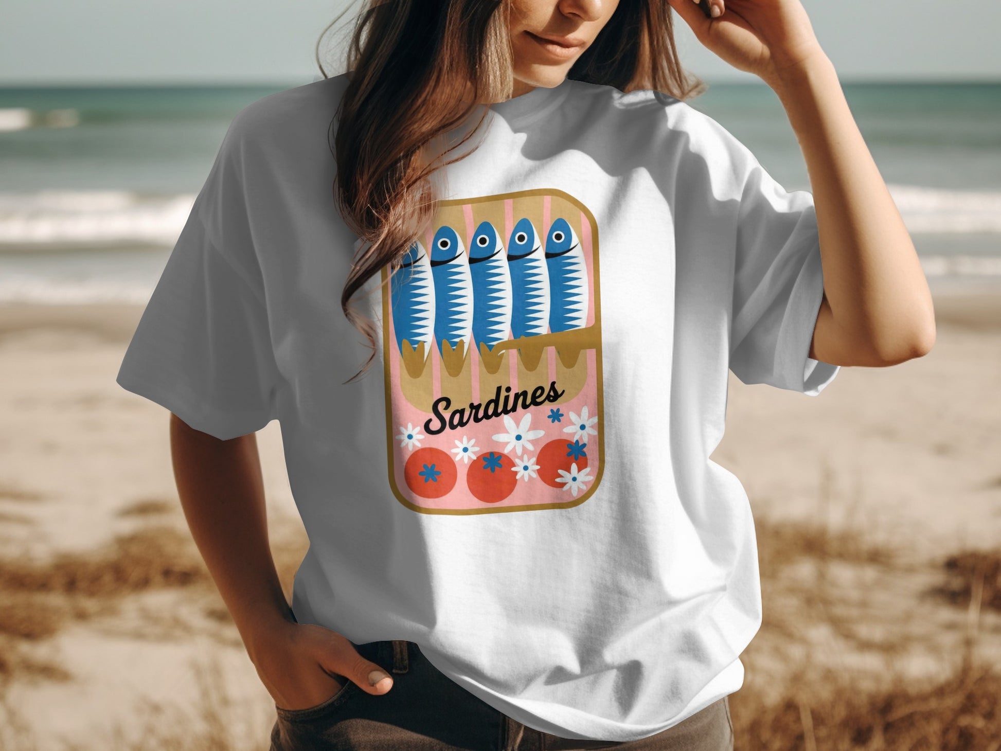 White t-shirt with cartoon sardines in a pink tin can with flowers.