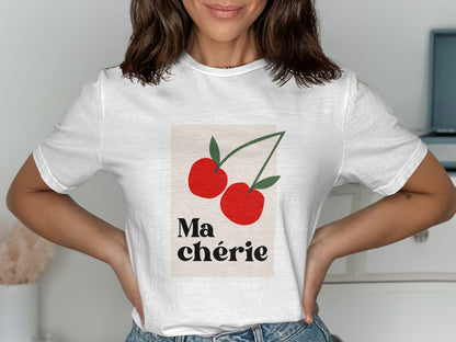 White t-shirt with graphic of two red cherries and "Ma Chérie" text.
