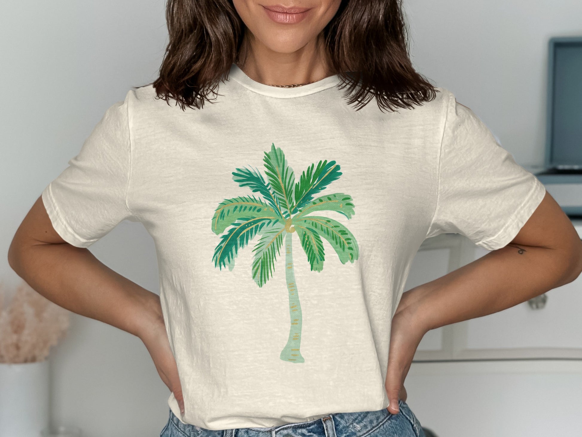 Cream t-shirt with a stylized green palm tree graphic.