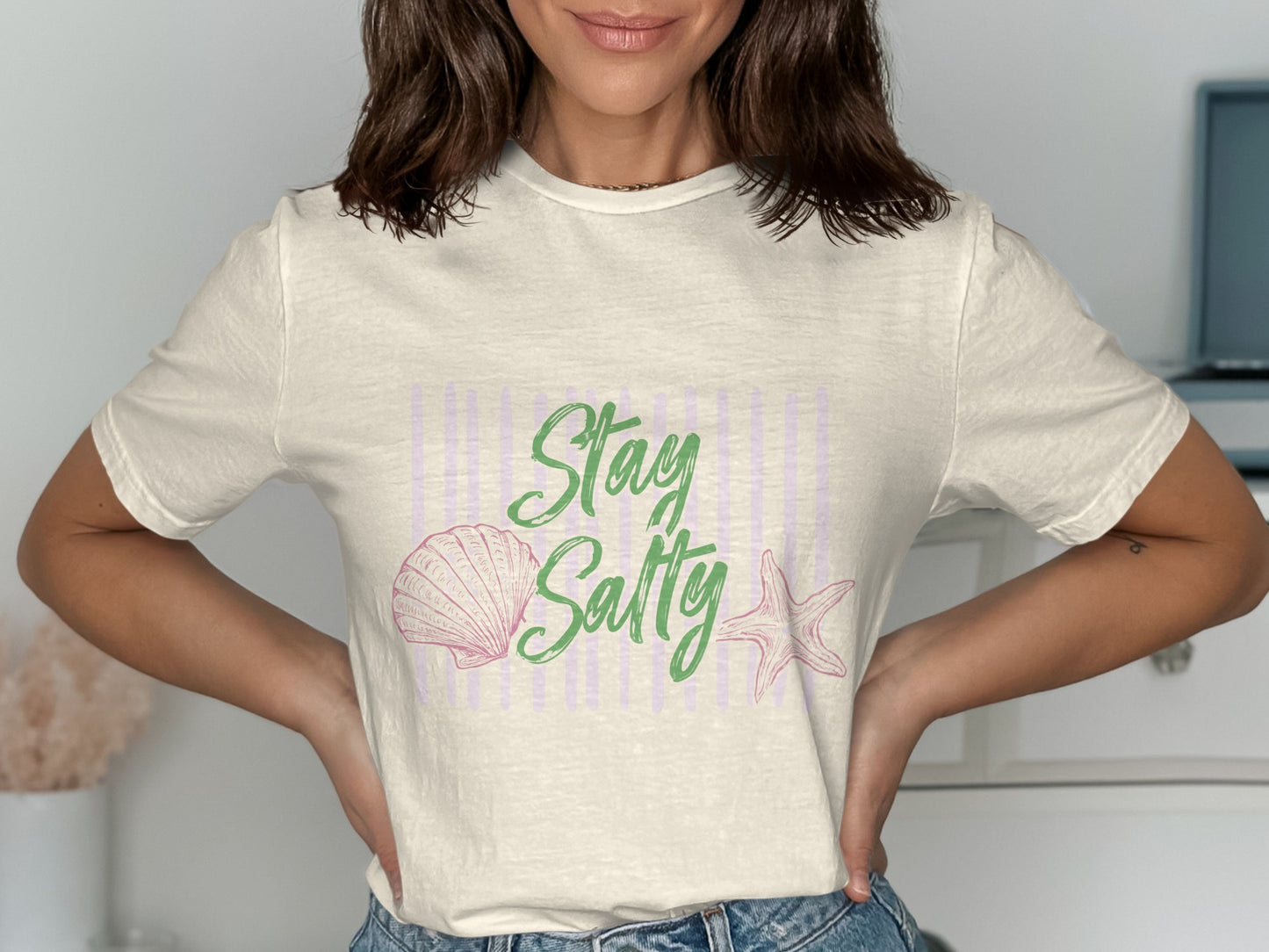 Cream t-shirt with pink seashell, starfish, and "Stay Salty" text.