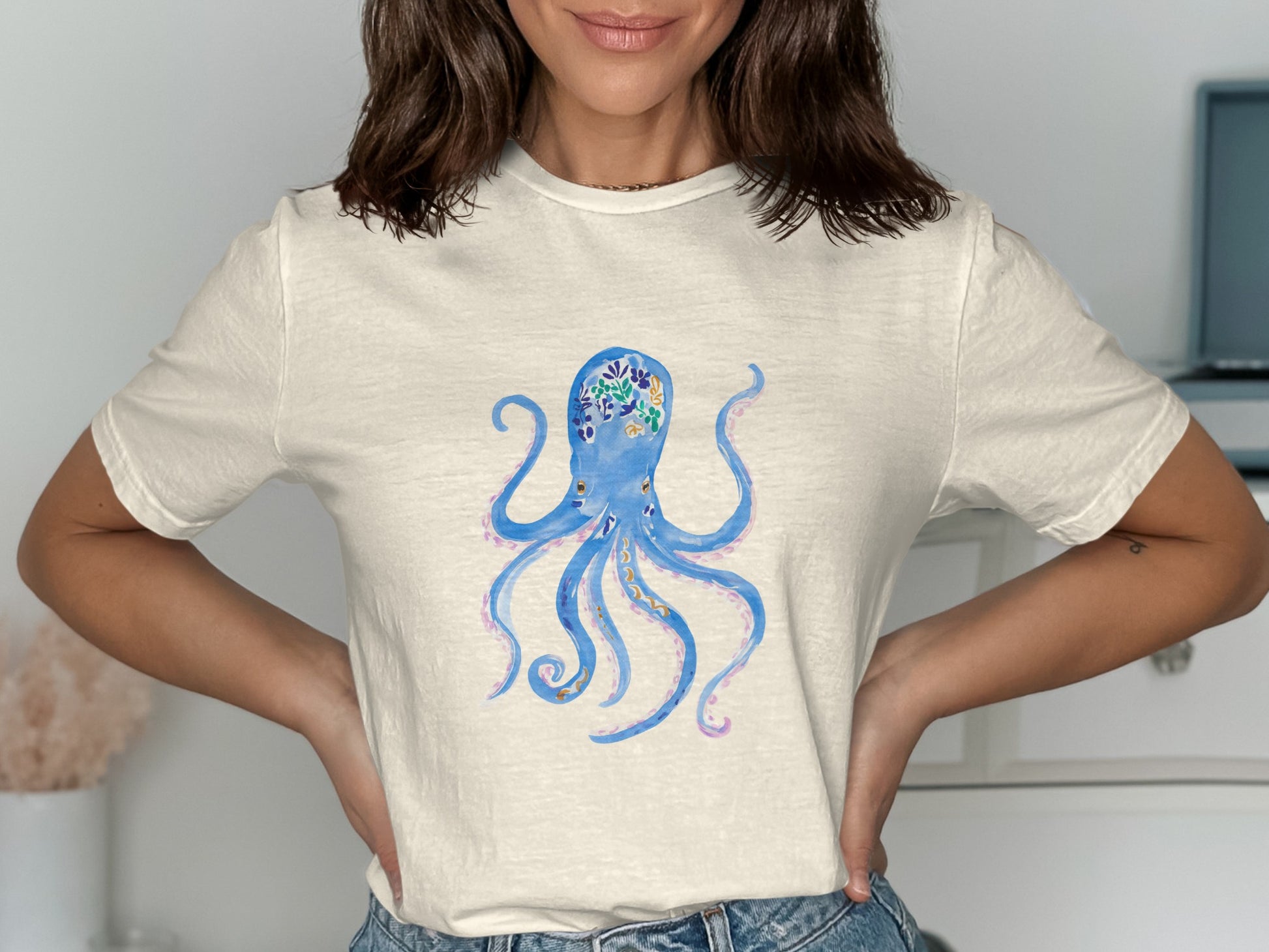 Cream t-shirt with a watercolor blue octopus graphic.