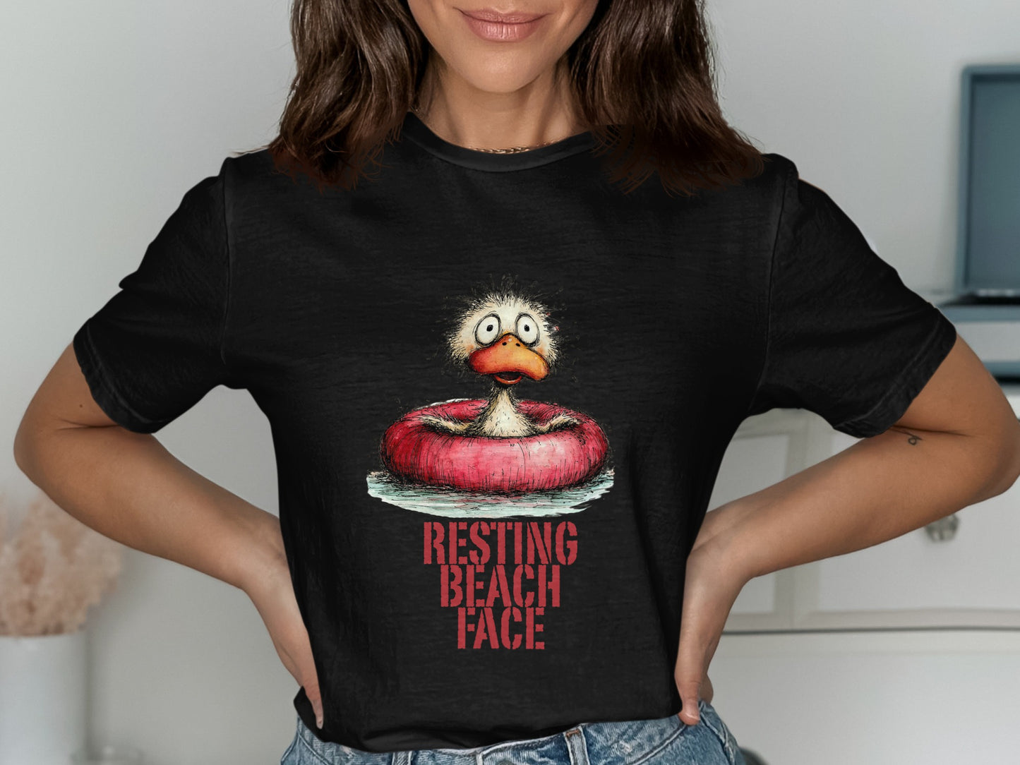 T-shirt with cartoon duck in inner tube, "Resting Beach Face" text.
