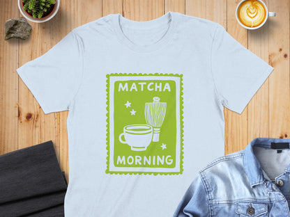 White t-shirt with green graphic of matcha whisk, cup, and text "MATCHA MORNING".