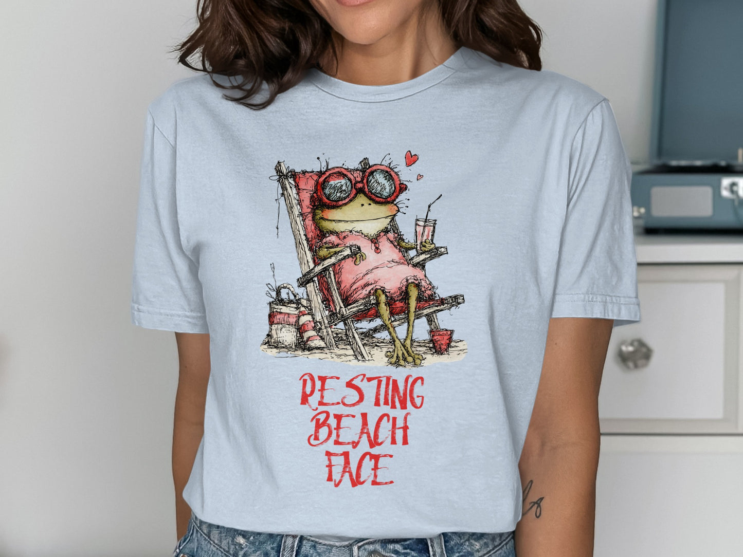 Frog in sunglasses and pink dress relaxing in a beach chair.