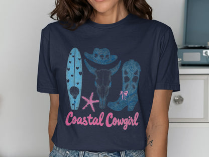Coastal Cowgirl graphic tee with surfboard, bull skull, and cowboy boot.
