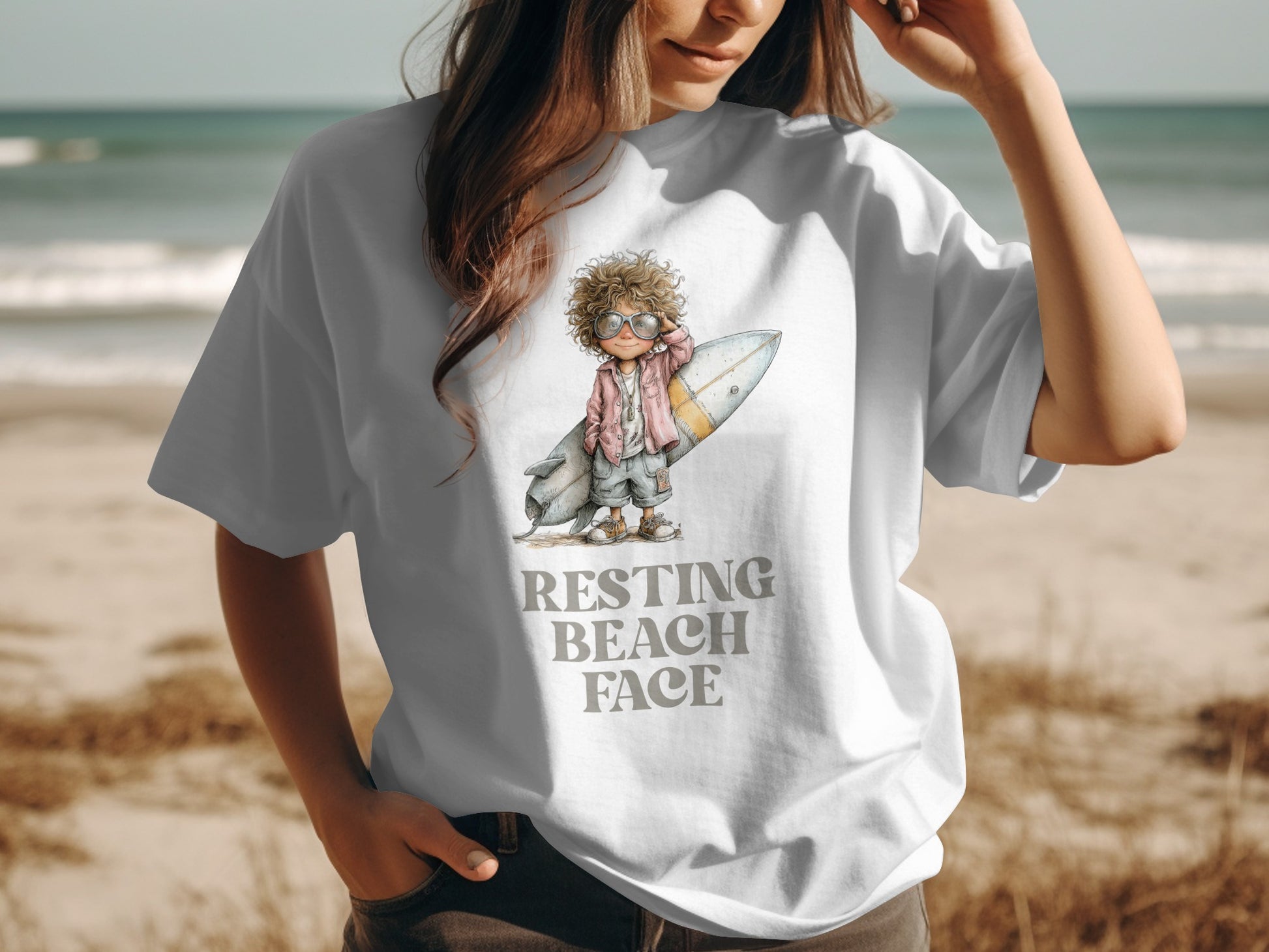 Woman wearing a white t-shirt with "Resting Beach Face" and surfboard graphic.